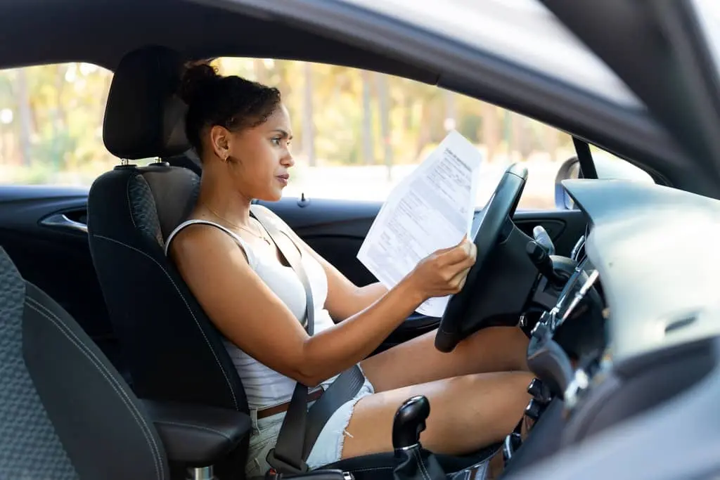 lemon-law-driver-reviewing-vehicle-paperwork